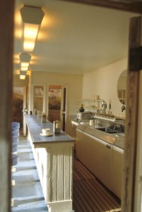 Behind the kitchen counter looking toward the front. Duckboards on the floor.